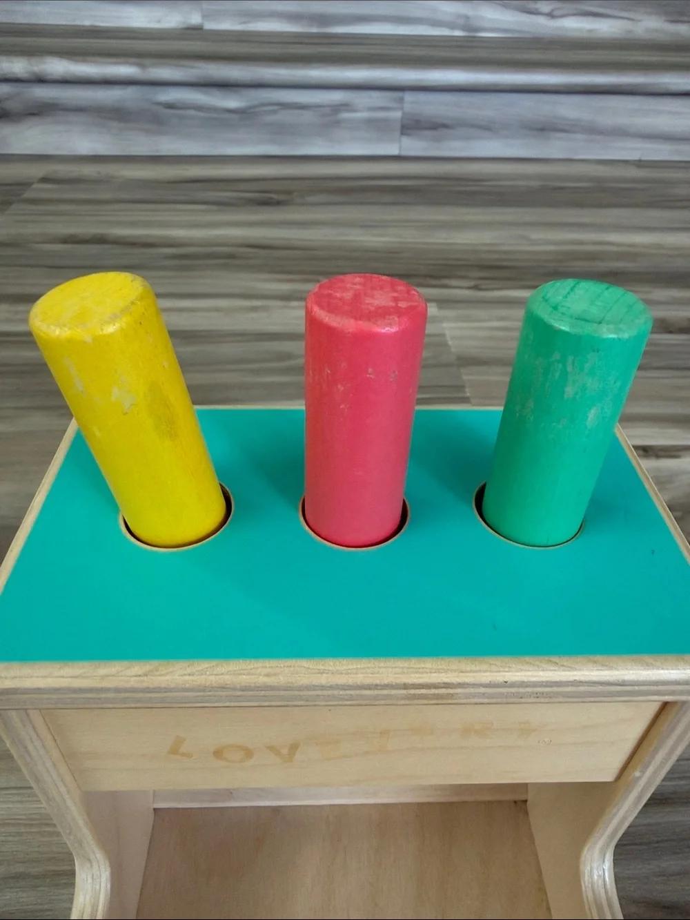 Lovevery Wooden Peg Drop Toy - Yellow, Red & Green Pegs